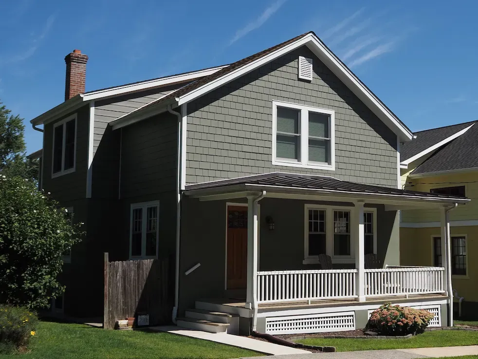Sage green Cedar Ridge composite shake siding on home by Affordable Siding, Windows & Roofing