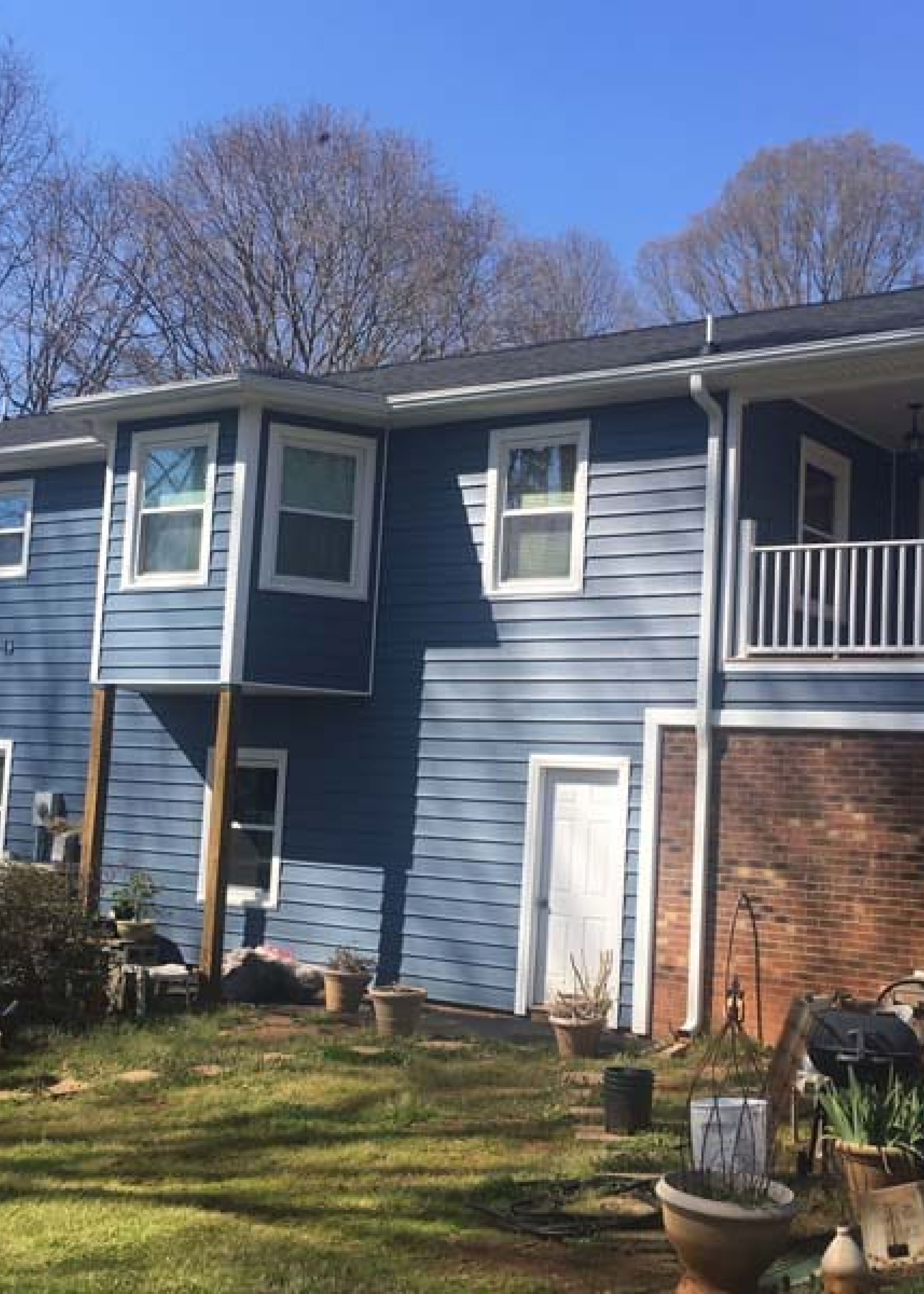 A Two-Story House With Blue Siding | Siding and Windows