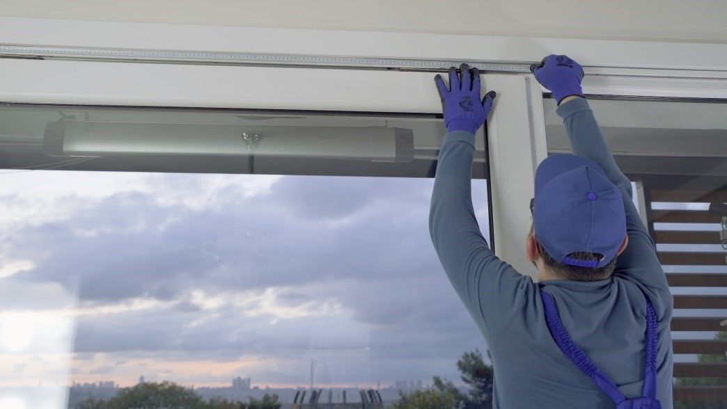 A Man Installing a Window | Siding or Windows