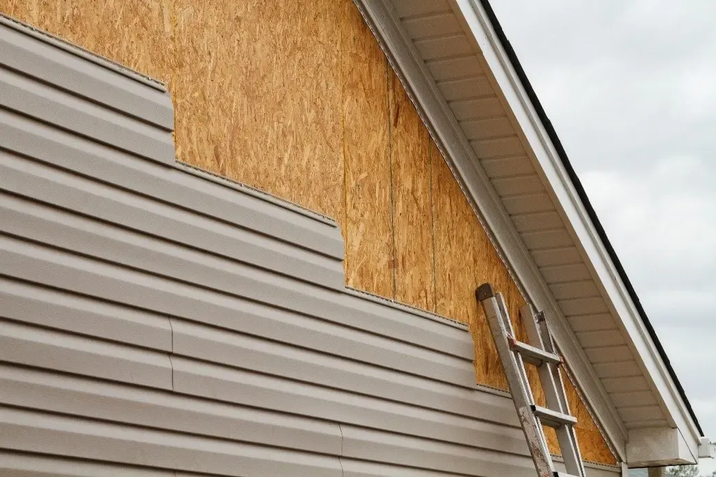 Affordable Siding, Windows & Roofing installing vinyl siding over house sheathing