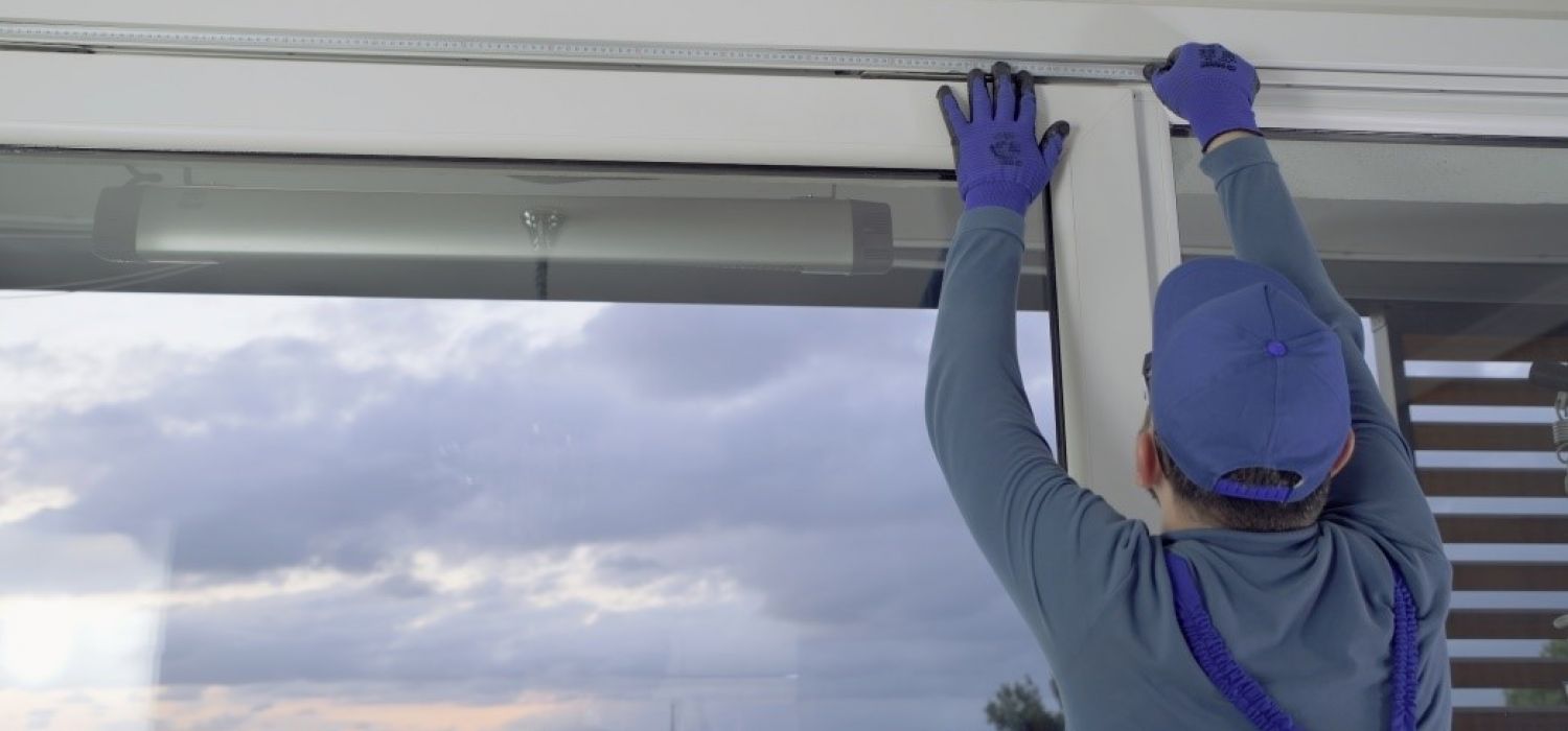 a man installing a window